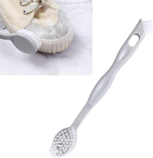 Shoe cleaning brush with grey handle and white bristle end plus speckled scrub head