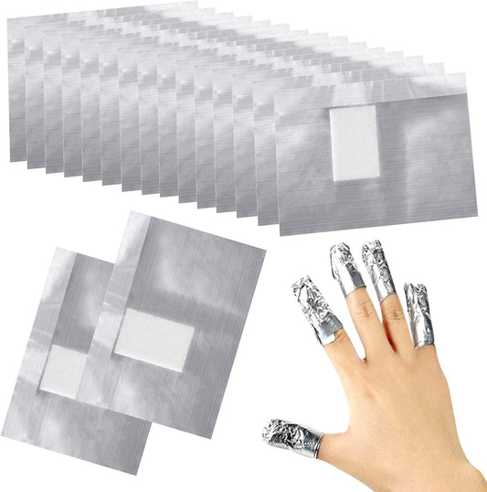 Silver nail foil sheets and wrapped nails for foil nail art application.