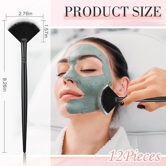 Facial fan brush with black handle and soft bristles applying mask