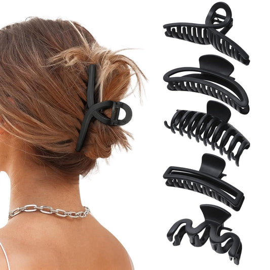 Set of 5 matte black large claw hair clips with ridged grip, shown on hair