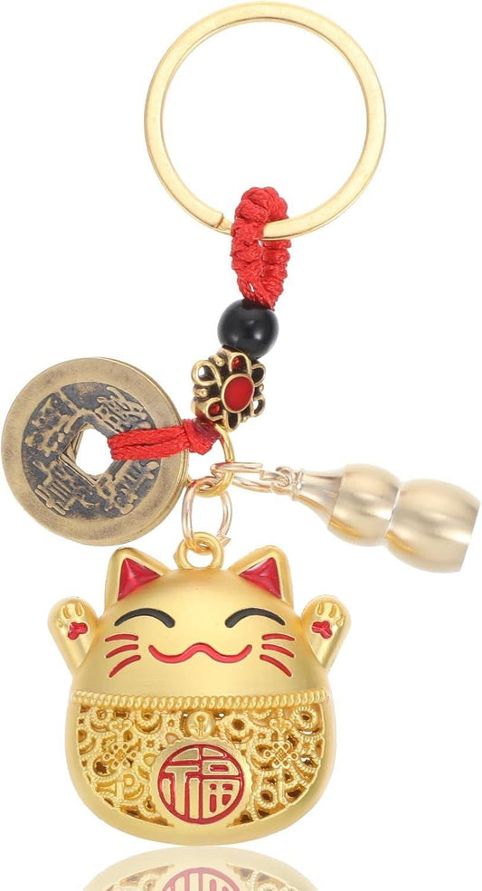 Lucky cat keychain with red tassel, gold charm, and round coin disc