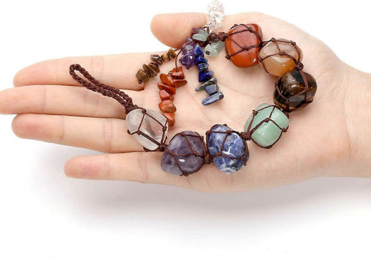 Gemstone bead ornament laid on open palm, multicolor stones on cord