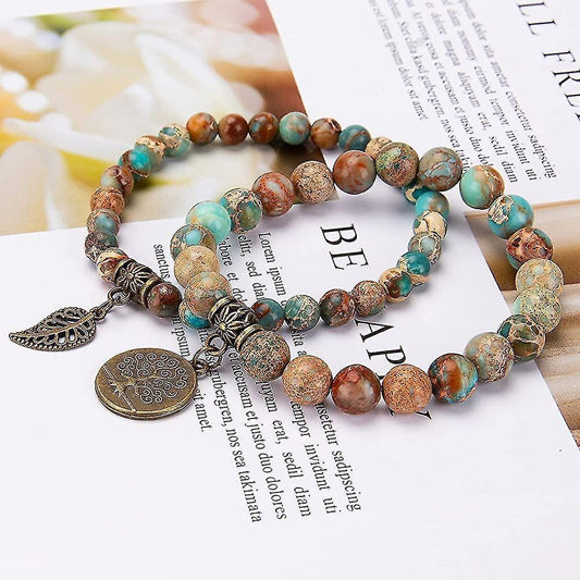 Multi-charm beaded bracelet with turquoise and brown stones, leaf dangle and round pendant