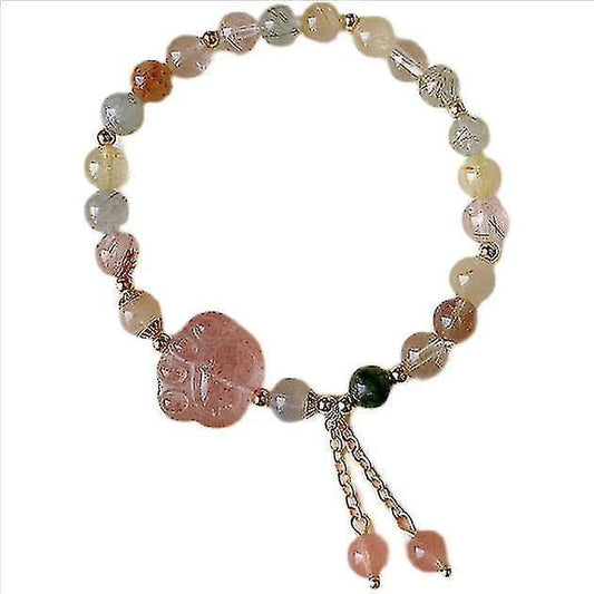 Pink and clear bead bracelet with carved pink charm and metal tassel links