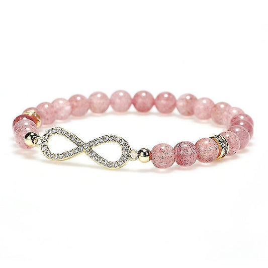 Pink round bead healing bracelet with infinity charm, gold spacers, and small dark beads