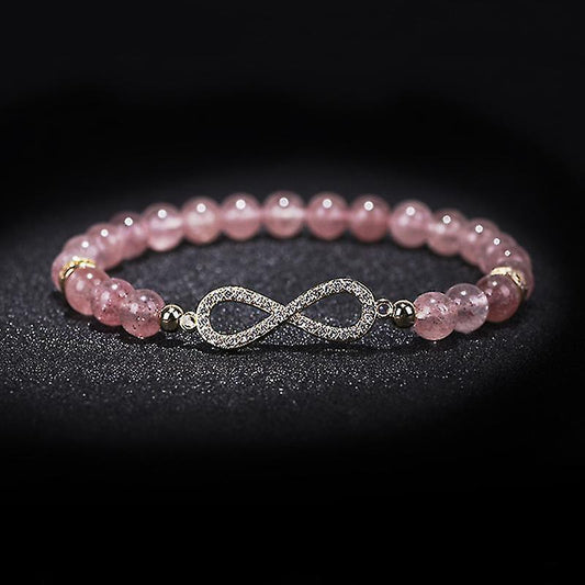 Pink crystal bead bracelet with infinity charm clasp and gold-tone accents with dark beads