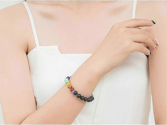 Multicolor beaded bracelet on a woman’s wrist with a dark bead section and metal accents