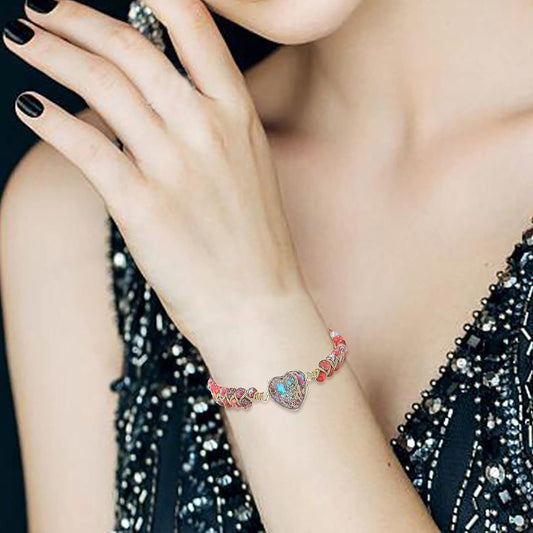 Heart charm beaded bracelet with turquoise stone centerpiece on wrist