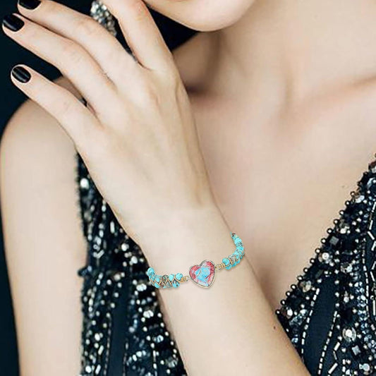 Turquoise beaded bracelet with heart charm on wrist