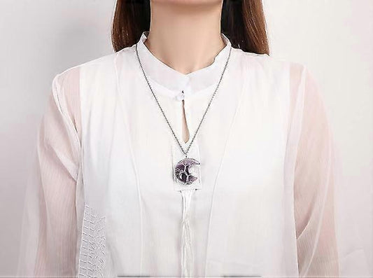 Purple crescent moon pendant necklace on a chain with tree-of-life wirework