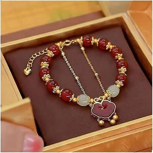 Red bead charm bracelet with gold-tone chain and heart pendant