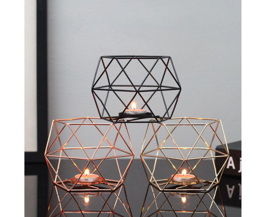 Geometric metal candle holder set with three open cage frames, warm light candles