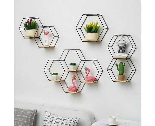 Set of golden hexagonal wall shelves with small planters and decorative decor