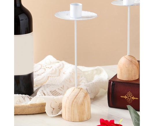 Set of white candlesticks with round holders and light wood bases