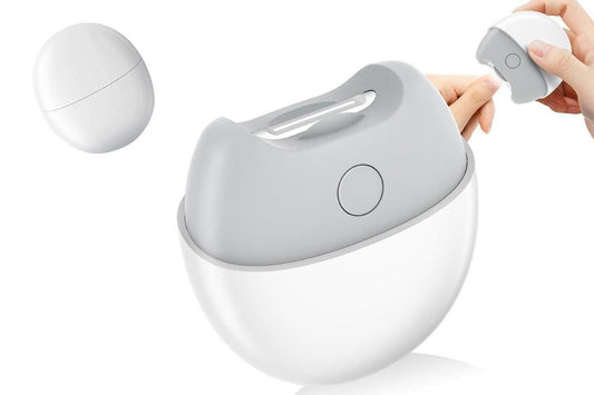 Electric nail clipper held in hand, white and gray body