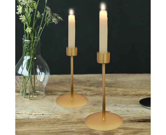 Golden metal candlestick holder pair with round bases and short cylindrical top cups