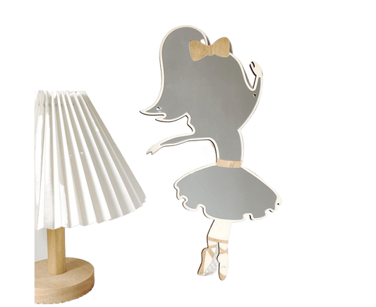 Wall-mounted ballet girl mirror with gray reflective finish, gold bow, and skirt