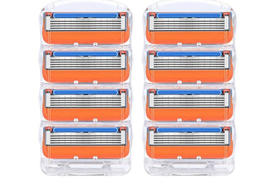 Razor blade refills, clear case with multiple orange-and-blue cartridges.