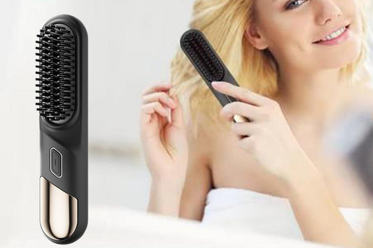 Black mini hot comb hair straightener brush held by hand with round tip bristles
