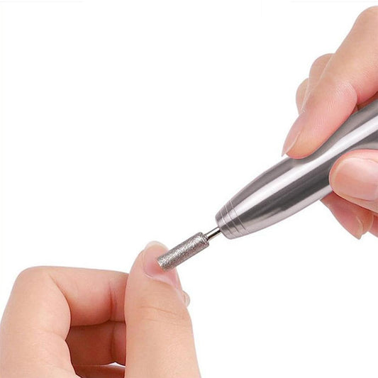 Cordless electric nail drill with silver bit attachment held by fingers