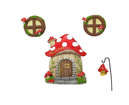 Multicolor mushroom house yard ornament with welcome roof, door, and two round wall pieces.