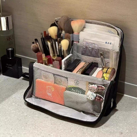 Black stand-up toiletry bag with clear mesh front pocket and multiple compartments
