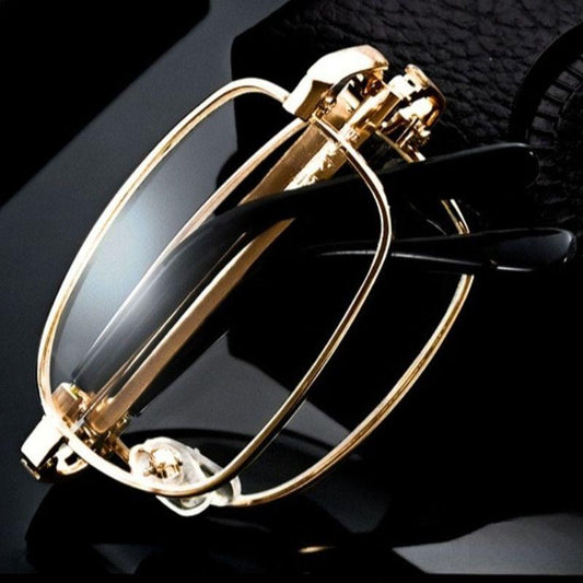 Gold metal foldable reading glasses with clear lenses, oval frames and hinge detail