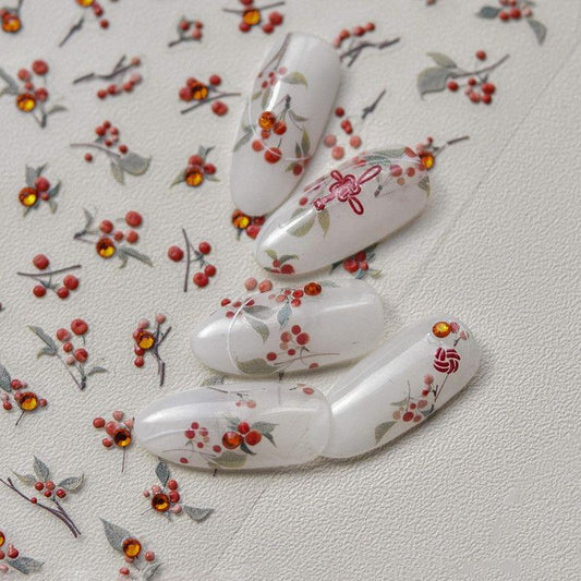 Floral nail art stickers with red and orange blossoms on white nails