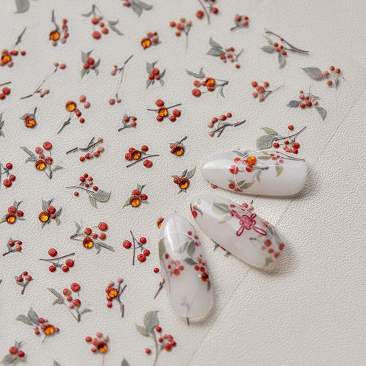 Floral nail art stickers with small red blooms on white nail tips