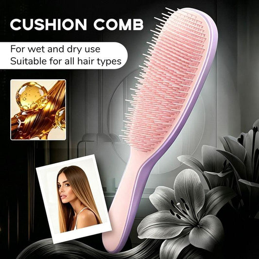Purple hair massage brush with pink silicone cushion teeth and curved handle