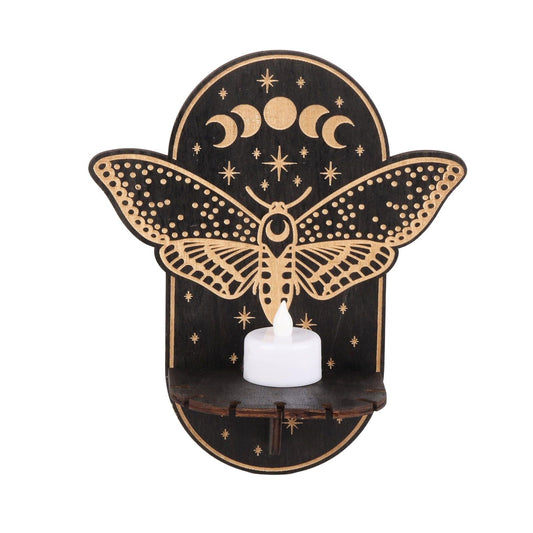 Butterfly wooden candle holder with star-and-moon cutout and white lit candle