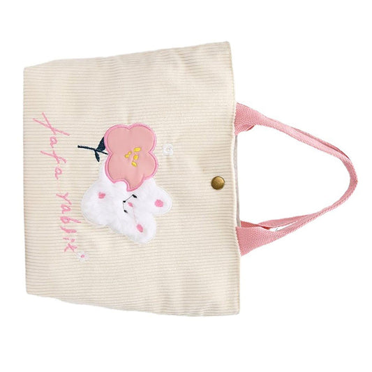 Cream corduroy tote with pink handle, snap button, bunny and flower front applique