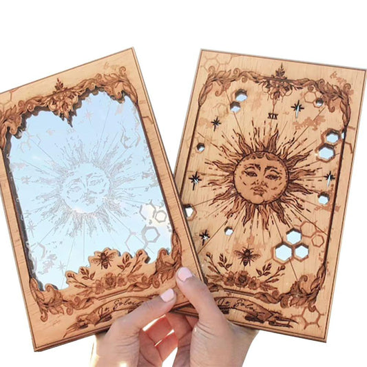 Wood-framed tarot card mirror with ornate sun face and hexagon pattern