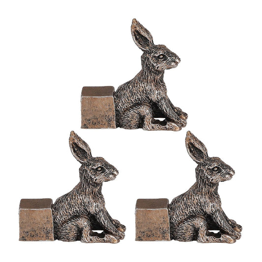 Set of three rabbit flowerpot feet, dark textured resin with square base blocks
