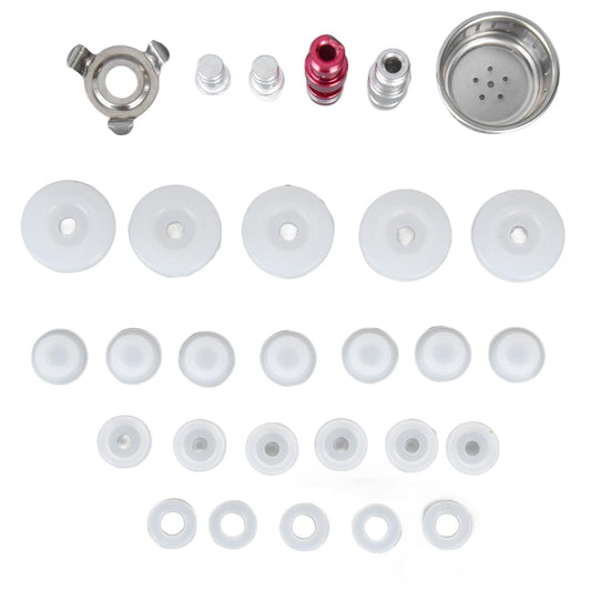 Electric pressure cooker accessory set showing metal valve parts, white gasket discs, and strainer