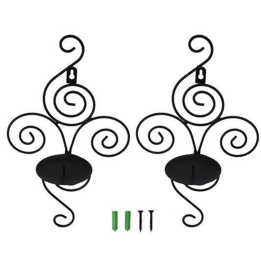 Two wall-mounted candle holders with spiral scroll arms and black round candle plates.