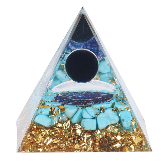 Turquoise crystal pyramid with gold glitter, black stone circle, chakra symbol.