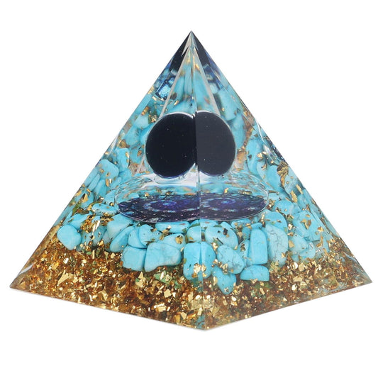 Turquoise crystal pyramid with gold glitter, two black stone circles, chakra symbol.