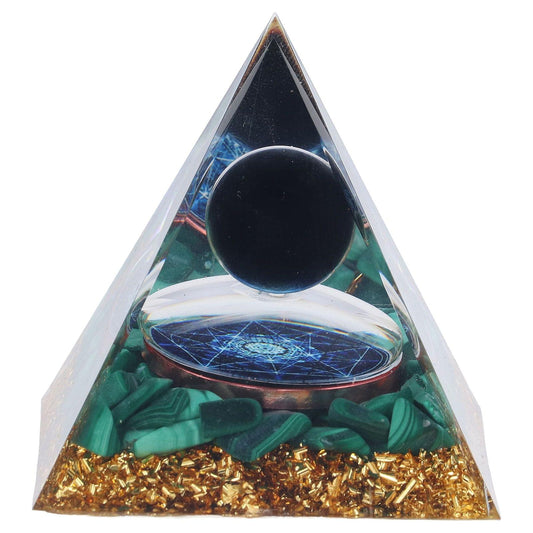 Orgone gemstone pyramid from side view with black sphere, blue sacred circle, teal stones, gold glitter
