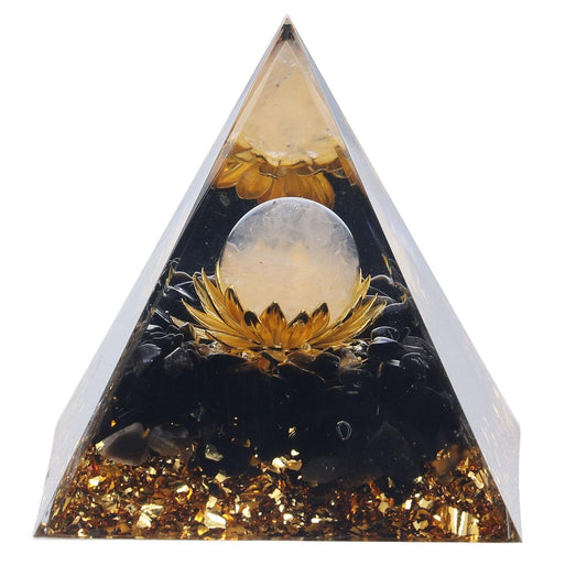 Orgone pyramid decoration with dark glass, gold glitter flecks, and light crystal center