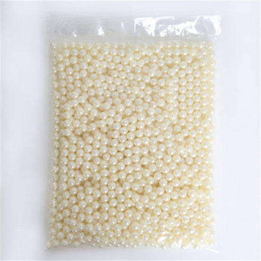 Packet of small white pearl beads, tightly packed in clear bag