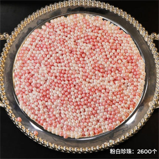 Circular pearl bead tray filled with pink and white beads, framed by gold tone beading