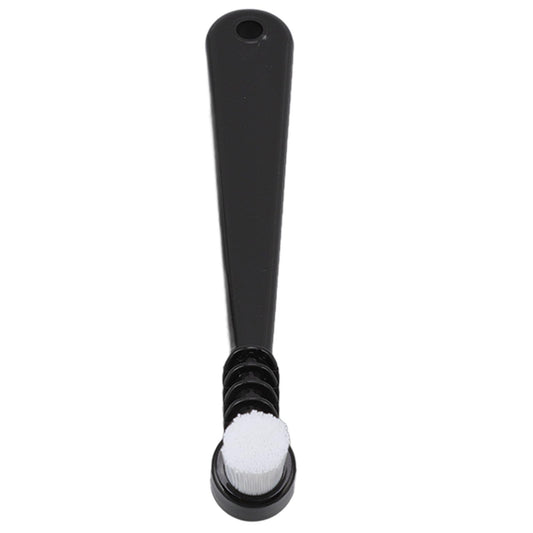Coffee machine cleaning brush tool with white bristle head on black shank