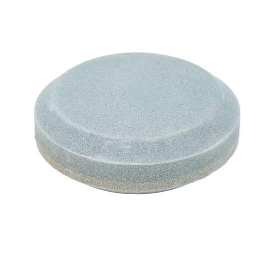 Double-sided round sharpening stone, light blue-gray abrasive surface, top view.