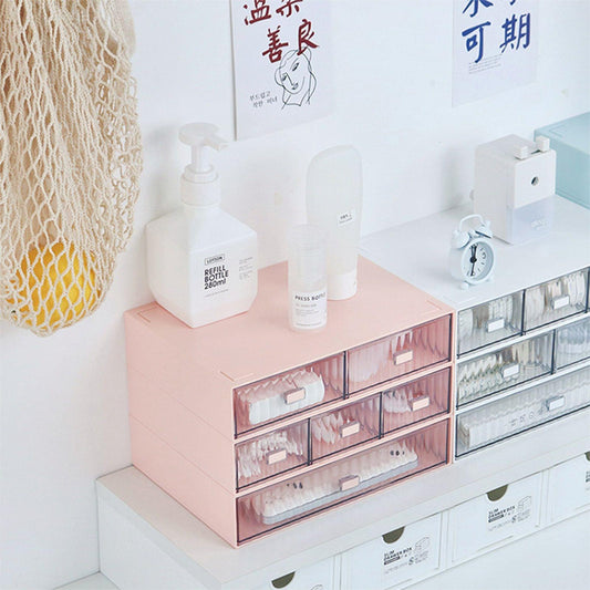 Striped pink plastic drawer organizer with multiple stacked clear drawers