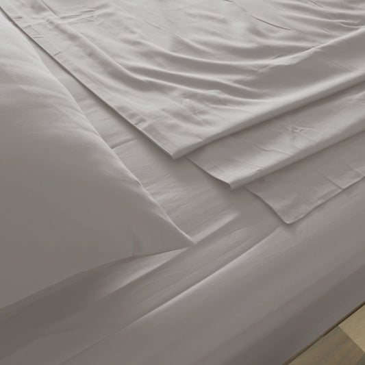 Dove gray fitted sheet with crisp seams and smooth woven fabric folds