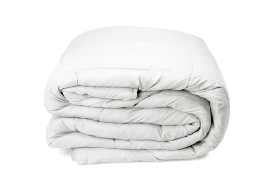 White quilt folded into a compact stack