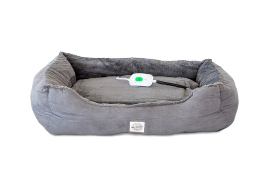 Grey heated pet bed with a visible electric controller on the inner base