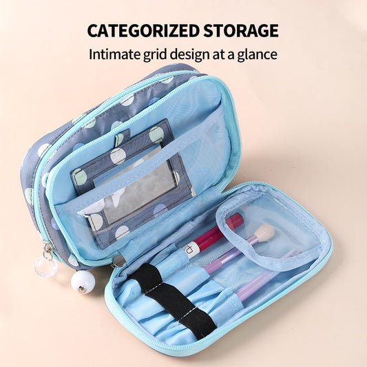 2-layer polka-dot makeup bag opened, showing compartments and brush slots, light blue interior