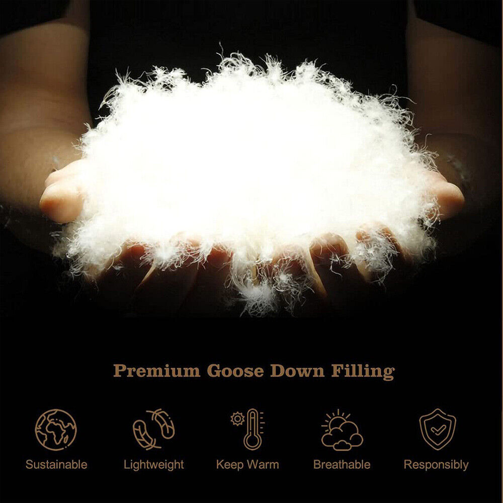 Goose down filling puff in a hand, showing soft white loft